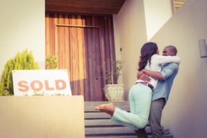 A couple entering their new house